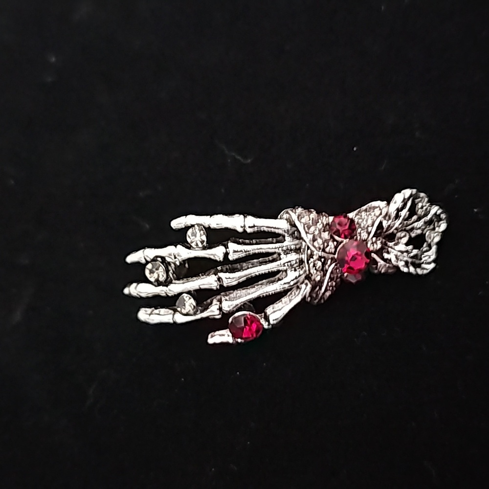 Brooch Skeleton hand with red gemstones